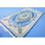 KIRMAN CARPET, principally dark blue and fawn having a large and elaborate floral centre medallion