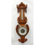 A GOOD EDWARDIAN CARVED OAK CASED ANEROID BAROMETER WITH THERMOMETER, 37" (34cm) high
