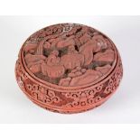 EARLY 20TH CENTURY ORIENTAL CINNABAR LACQUER CIRCULAR BOX AND COVER carved with figures in a