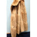 A MUSQUASH FUR LADY'S COAT, fold-over collar, two hook and eye fastenings, front seam pockets,