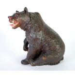 LATE NINETEENTH CENTURY BLACK FOREST CARVED WOOD BEAR, depicted in a seated post with a snarling but