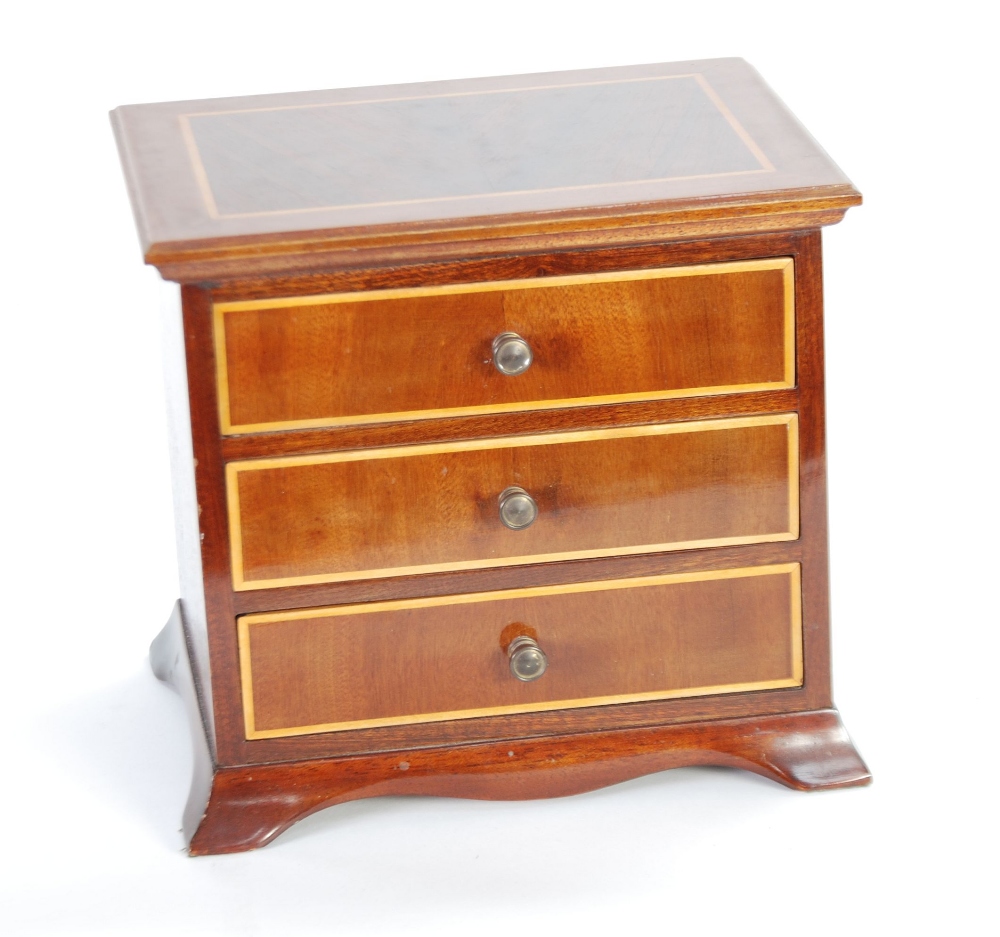 REPRODUCTION 'APPRENTICE PIECE' LINE INLAID MAHOGANY SMALL CHEST OF THREE DRAWERS, on splayed