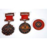 THREE NORTH KOREAN ENAMELLED COPPER MEDALS, two with ribbons, one stamped 1945.7.7 to the back,