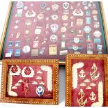 FRAMED COLLECTION OF MAINLY GILT METAL AND ENAMEL BADGES RELATING TO COMMUNIST RUSSIA, many