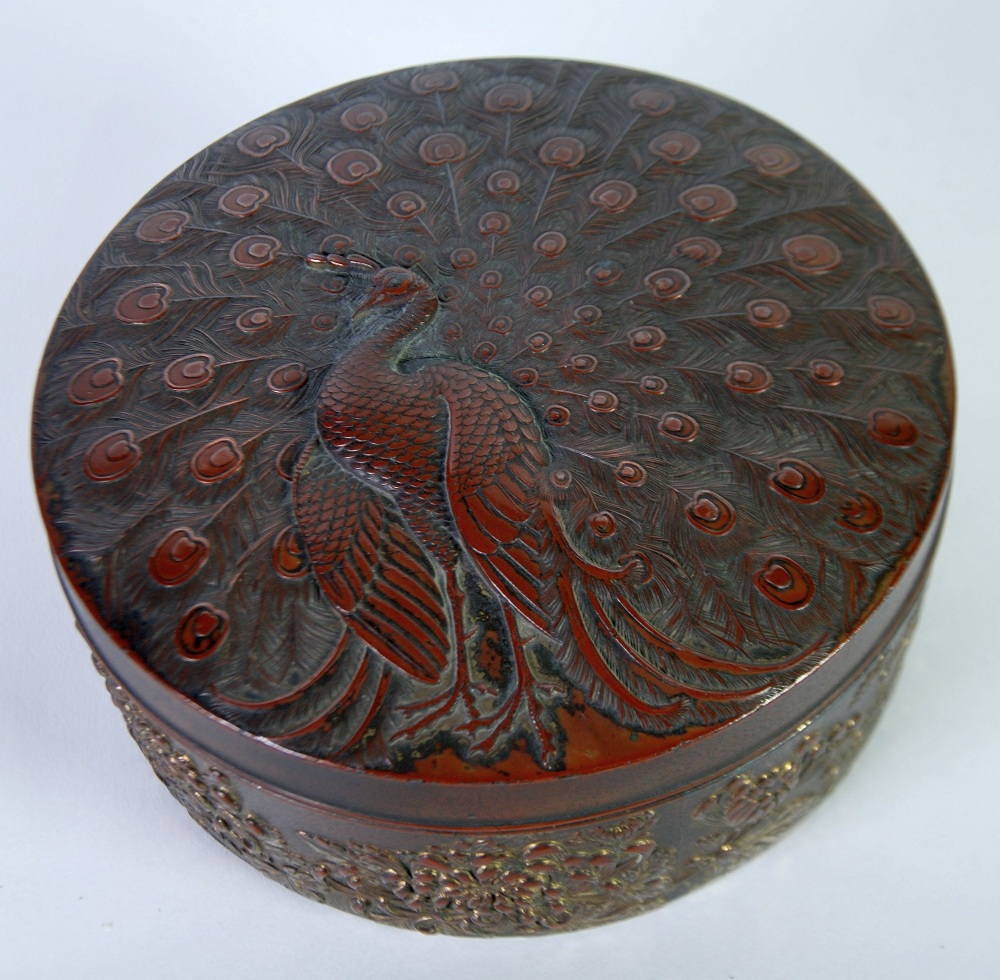 ORIENTAL TINNED COPPER ANTIMONY BOX, circular  form, the cover embossed with a displaying peacock,
