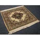 MODERN PERSIAN RUG, square with petal shaped centre medallion, on a cream field with sprandrels, the