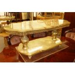 A MODERN ONYX TWO TIER COFFEE TABLE, THE SHAPED TOP WITH BRASS DECORATIVE FRIEZE ON BRASS BALUSTER