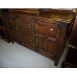 ERCOL GOLDEN DAWN ELM SIDEBOARD WITH A NEST OF FOUR CENTRE DRAWERS AND FLANKED BY TWO CUPBOARDS, 58"