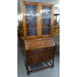 1930's OAK BUREAU, WITH SLOPING FALL FRONT, TWO LONG DRAWERS, ON BALUSTER LEGS WITH STRETCHERS AND