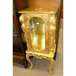 A MODERN PETITE GILT CABINET THE SHAPED TOP OVER THREE GLAZED SIDES, MIRROR BACK, SINGLE GLASS