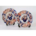 PAIR OF JAPANESE IMARI CIRCULAR PLAQUES, decorated with urns of flowers, scalloped borders, unmarked