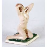ROYAL DUX POTTERY FIGURE OF A NAKED FEMALE, modelled seated in stylised pose, on a moulded lozenge