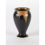 A 1930's FIELDING'S CROWN DEVON VASE, decorated with stylised leaves and flowers on a matt-black
