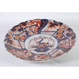 LARGE JAPANESE IMARI CIRCULAR PLAQUE WITH SCALLOPED EDGE, the centre decorated with a bowl of
