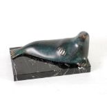 ITALICA MODERN SPANISH BRONZE MODEL OF A RECLINING WALRUS, on an oblong black veined marble base,