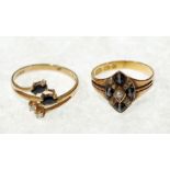 A 9ct GOLD CROSSOVER RING SET with two navette shape dark sapphires and two tiny diamonds, 2 gms