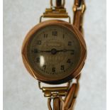 LADY'S 9CT GOLD CASED WRIST WATCH, 15 jewel movement, silvered arabic dial, London 1930, on