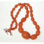 GRADUATED AMBER BEAD NECKLACE, formed of 37 graduated oval beads, largest bead 30mm long,