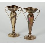 PAIR OF EDWARDIAN SILVER TRUMPET VASES, wavy rims with tapering stems and thin scroll handles, on