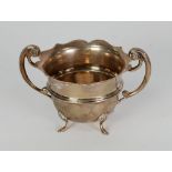 SILVER TWO HANDLED SUGAR BOWL, with cyma edge, scroll handles and raised on four pad feet,