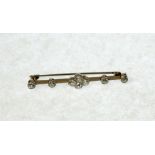 DIAMOND SET BAR BROOCH centrally set with a quatrefoil of four diamonds flanked by four further