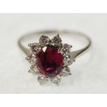 RUBY AND DIAMOND CLUSTER RING, claw set with oval mixed cut ruby and a surround of ten round