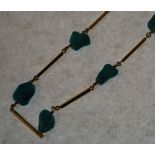 TURQUOISE AND 18CT GOLD BAR LINK NECKLETE, formed of 11 rough turquoise beads, alternating with 11