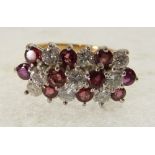 an 18ct YELLOW GOLD TINY DIAMOND AND RUBY SET RING, the white gold setting with seven alternate rows
