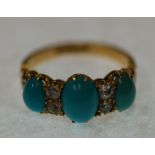 EDWARDIAN TURQUOISE AND DIAMOND SET RING, claw set with three graduated oval turquoise and four