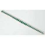 EMERALD AND DIAMOND SET BRACELET, formed of 31 graduated articulated links each set with an oval