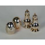 PAIR OF WEIGHTED SILVER EGG SHAPED PEPPERETTES, Birmingham 1905, AND A PAIR OF SILVER PEPPERETTES on