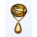 VICTORIAN LARGE CITRINE SET BROOCH, bezel set oval mixed cut citrine in gilt metal rope frame,