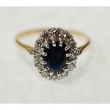 SAPPHIRE AND DIAMOND CLUSTER RING, claw set with oval mixed cut sapphire and a surround of twelve