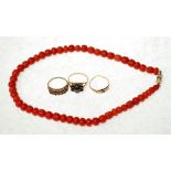 TWO 9CT GOLD GARNET SET RINGS AND A 15CT GOLD SAPPHIRE AND BLUE STONE RING AND A CORAL BEAD NECKLACE