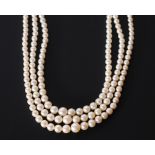 TRIPLE STRAND NECKLACE OF GRADUATED CULTURED PEARLS with silver and marcasite clasp