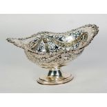 EARLY TWENTIETH CENTURY PIECED SILVER PEDESTAL BASKET, lozenge form with cast foliate rim and