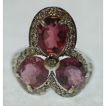 PINK TOURMALINE AND DIAMOND SET RING, set with three oval mixed cut pink tourmaline, approx. 7ct