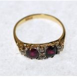 RUBY AND DIAMOND SET RING, boat shaped top set with two oval mixed cut rubies and a surround of four