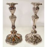 A PAIR OF VICTORIAN OLD SHEFFIELD PLATE CANDLESTICKS, with stamped soft solder filled scrolliated