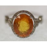 YELLOW SAPPHIRE AND DIAMOND SET RING, oval mixed cut yellow sapphire, approx. 5ct, with diamond