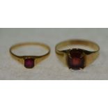 GARNET SET RING, claw set oval mixed cut garnet to the tapering unmarked gold band (tests 14-
