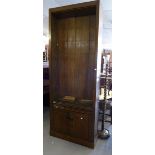 A TALL MAHOGANY OPEN BOOKCASE WITH FIVE ADJUSTABLE SHELVES AND A PAIR OF PANEL DOORS AT BASE (MADE