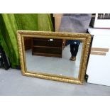 A LARGE OBLONG WALL MIRROR IN GILT OVOLO AND LEAF MOULDED FRAME, 32" HIGH, 44" WIDE OVERALL