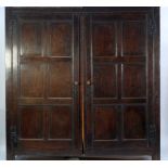 ANTIQUE OAK LARGE TWO DOOR CUPBOARD, with panelled doors and sides and exposed black metal cockshead