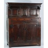 LATE 17th CENTURY CARVED OAK LARGE COURT CUPBOARD, the moulded canopy with drop finials, above a
