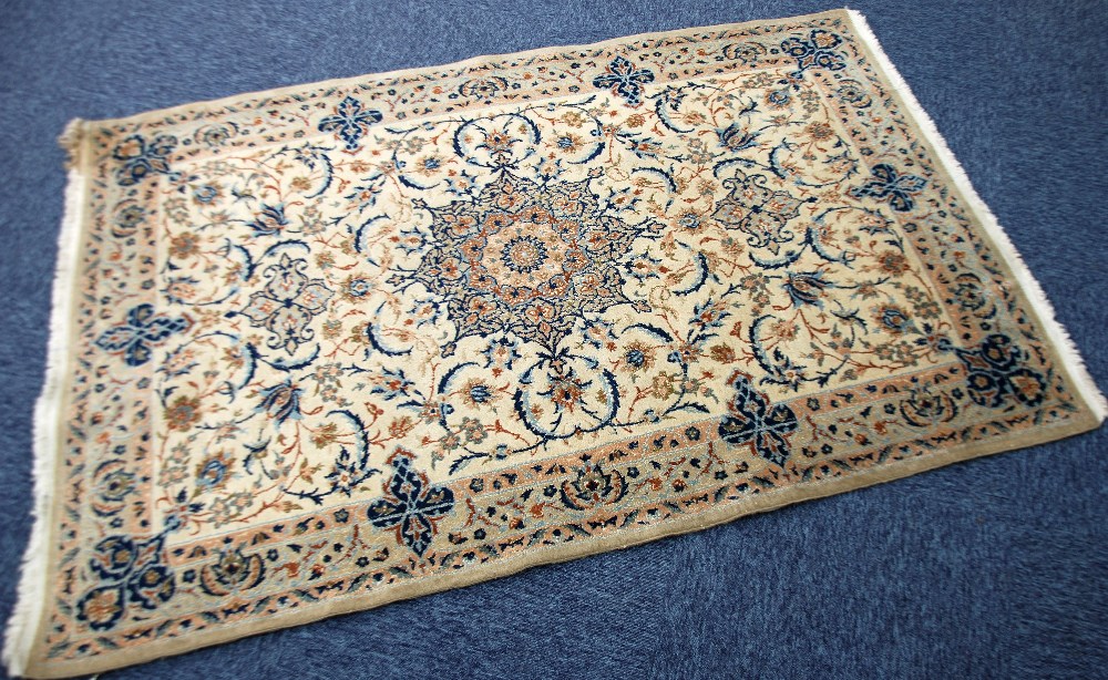 KASHAN PART SILK RUG, with circular petal pattern centre medallion with pendants on an off white