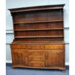 LATE EIGHTEENTH CENTURY OAK ENCLOSED DRESSER, the plate rack with moulded cornice and shaped