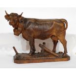 LATE 19th CENTURY/EARLY 20th CENTURY SWISS BLACK FOREST TYPE CARVED WOODEN COW, with bell around its