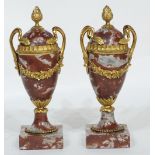 PAIR OF LATE 19th CENTURY FRENCH VEINED RED MARBLE ORMOLU MOUNTED TWO-HANDLED PEDESTAL URNS with bud