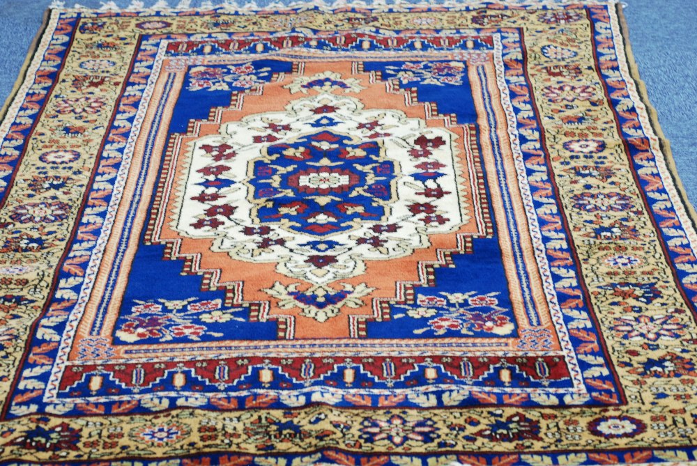 MODERN TURKEY WOOL PILE RUG of vibrant Persian design, the centre field with medallion within wide